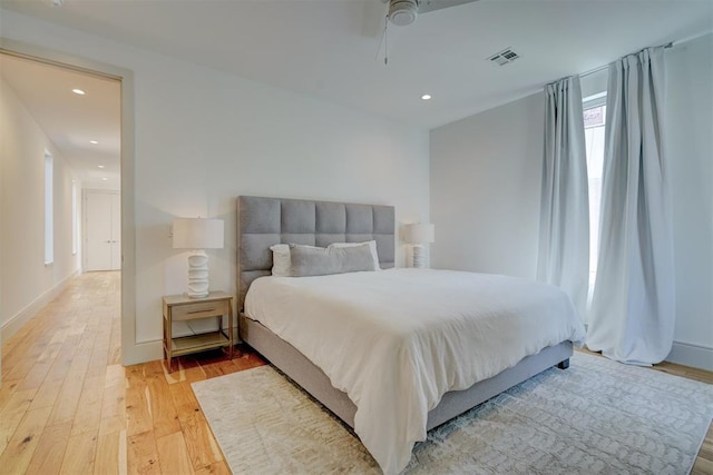 bedroom with visible vents, recessed lighting, light wood-type flooring, and baseboards