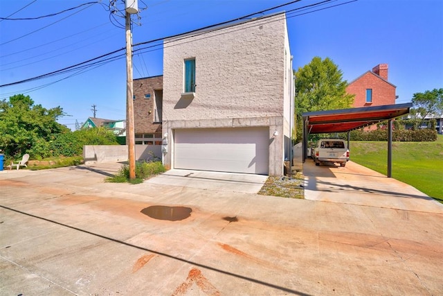 view of property exterior featuring a carport, a lawn, driveway, and an attached garage