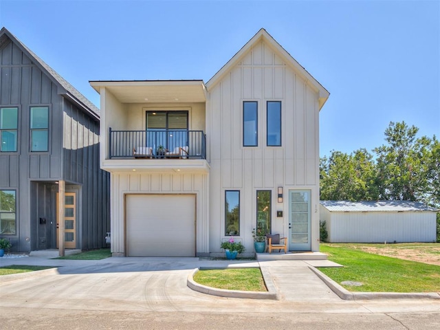 modern farmhouse style home with board and batten siding, driveway, and a balcony