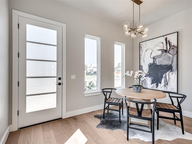 12 S Howard St, Edmond, OK 73003 - dining area featuring baseboards, light wood finished floors, and a chandelier