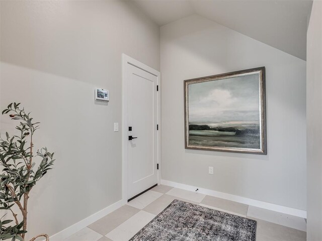 12 S Howard St, Edmond, OK 73003 - foyer entrance featuring baseboards and vaulted ceiling