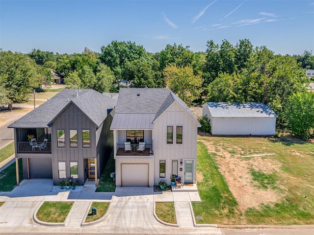12 S Howard St, Edmond, OK 73003 - view of front of home with a balcony, board and batten siding, and an attached garage