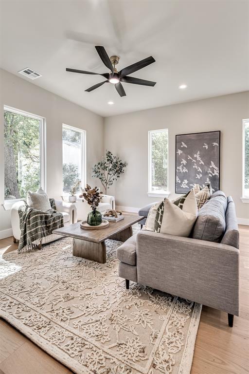 12 S Howard St, Edmond, OK 73003 - living area featuring light wood-type flooring, plenty of natural light, visible vents, and ceiling fan