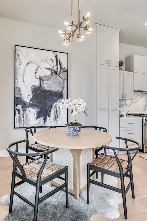 12 S Howard St, Edmond, OK 73003 - dining room featuring light wood-style floors, baseboards, and a chandelier