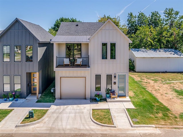 12 S Howard St, Edmond, OK 73003 - modern inspired farmhouse featuring board and batten siding, a shingled roof, driveway, a balcony, and an attached garage