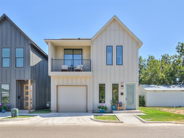 12 S Howard St, Edmond, OK 73003 - modern inspired farmhouse featuring a balcony, an attached garage, board and batten siding, and driveway