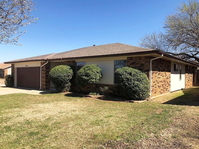 view of property exterior featuring a garage, brick siding, concrete driveway, and a lawn