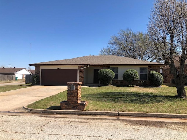 ranch-style house featuring a front lawn, concrete driveway, and an attached garage