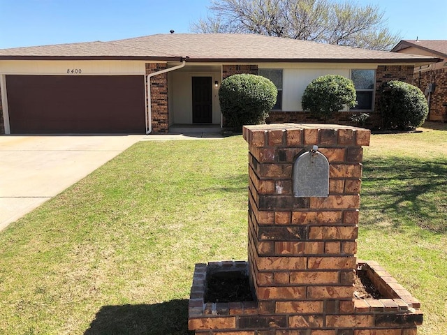 ranch-style home with concrete driveway, a garage, and a front yard