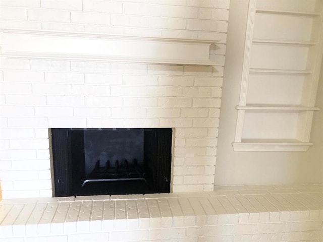 interior details featuring a brick fireplace