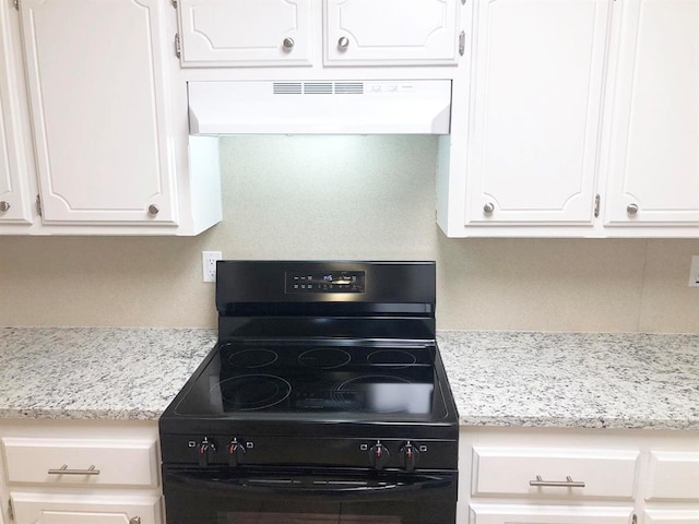 kitchen featuring white cabinetry, black / electric stove, and exhaust hood