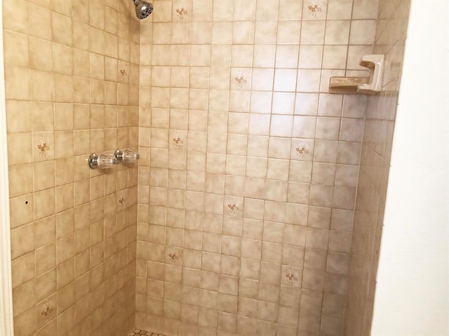 bathroom with a tile shower