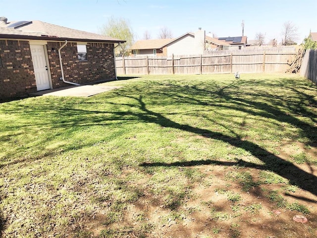 view of yard with a fenced backyard