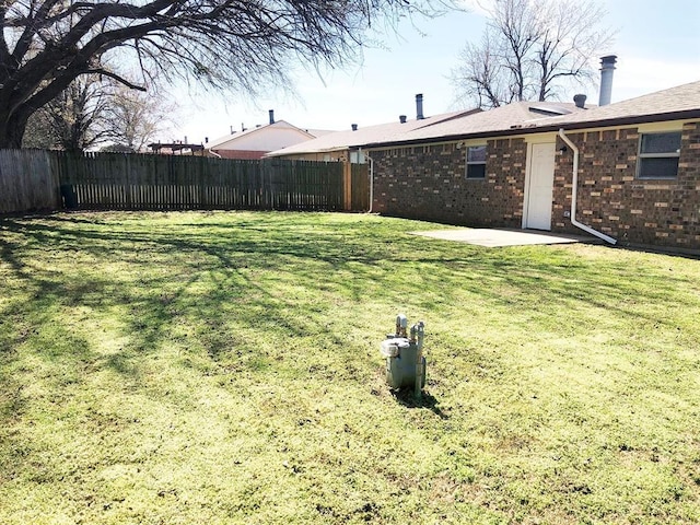 view of yard with a patio area and a fenced backyard