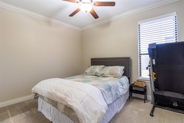 carpeted bedroom featuring crown molding, a ceiling fan, and baseboards