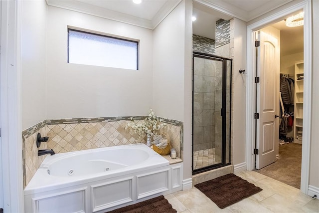 full bath featuring tile patterned flooring, a shower stall, crown molding, a walk in closet, and a tub with jets