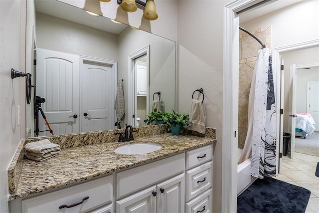 bathroom featuring tile patterned floors, vanity, and shower / tub combo