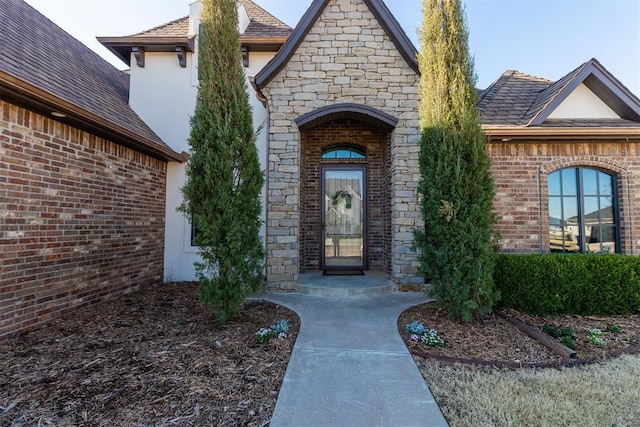 13216 Knight Island Dr, Oklahoma City, OK 73142 - doorway to property featuring stucco siding and stone siding