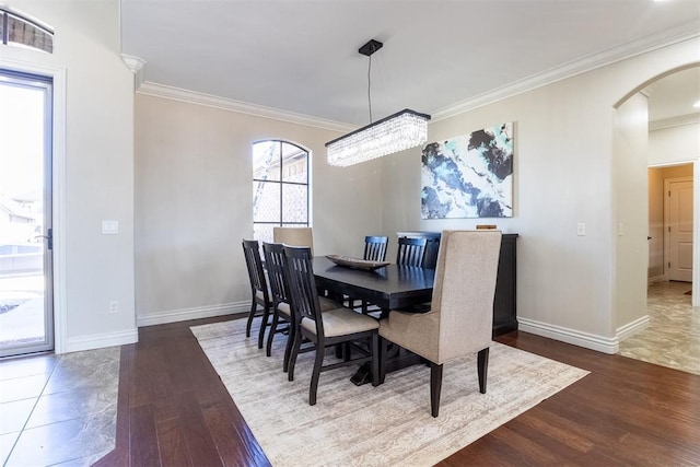 13216 Knight Island Dr, Oklahoma City, OK 73142 - dining space with visible vents, baseboards, arched walkways, ornamental molding, and wood finished floors