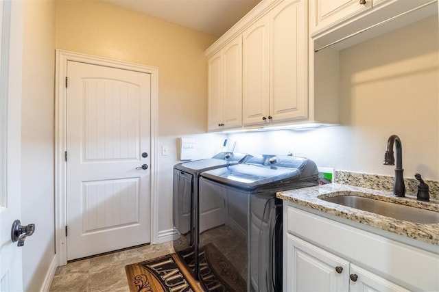 13216 Knight Island Dr, Oklahoma City, OK 73142 - laundry area with baseboards, washing machine and clothes dryer, a sink, and cabinet space