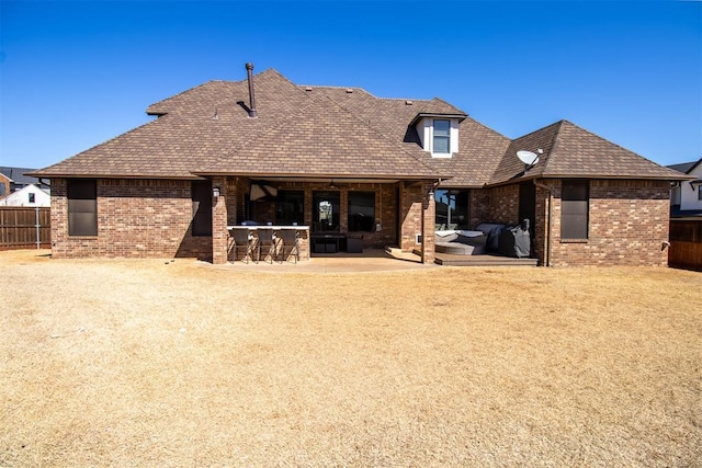 13216 Knight Island Dr, Oklahoma City, OK 73142 - rear view of house featuring a patio, brick siding, outdoor dry bar, and fence