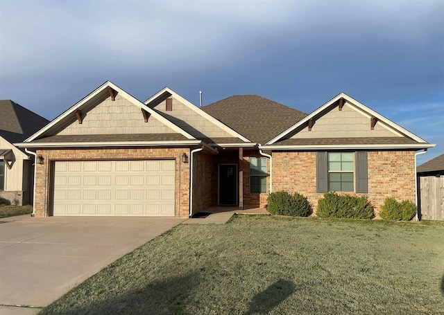 craftsman inspired home with a front yard, roof with shingles, concrete driveway, a garage, and brick siding