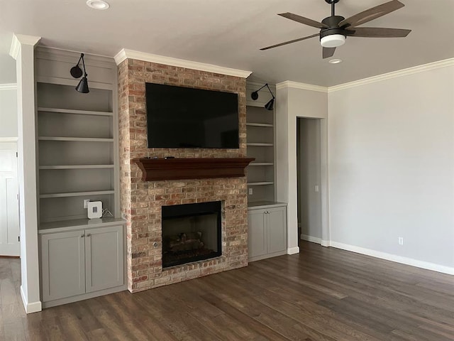 unfurnished living room with baseboards, ceiling fan, built in features, ornamental molding, and a fireplace