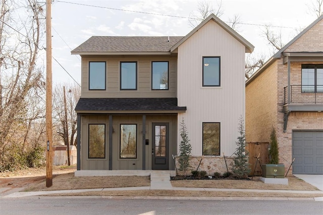 view of front of home with an attached garage, driveway, and a shingled roof