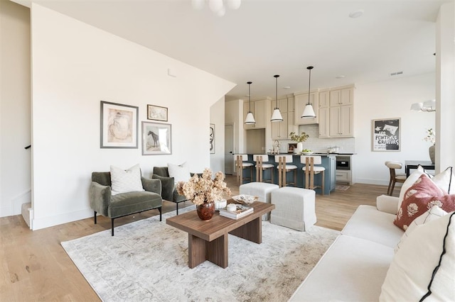 living area with light wood-style floors and baseboards