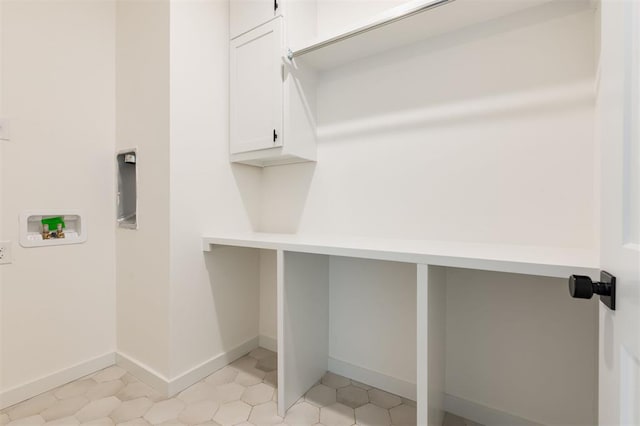 washroom featuring cabinet space, hookup for a washing machine, and baseboards