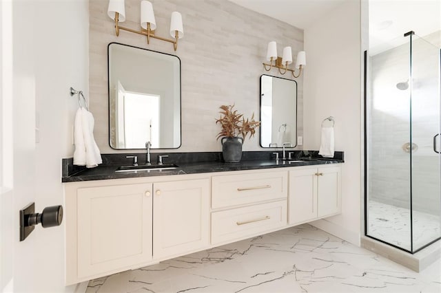 full bath with a sink, marble finish floor, a stall shower, and double vanity
