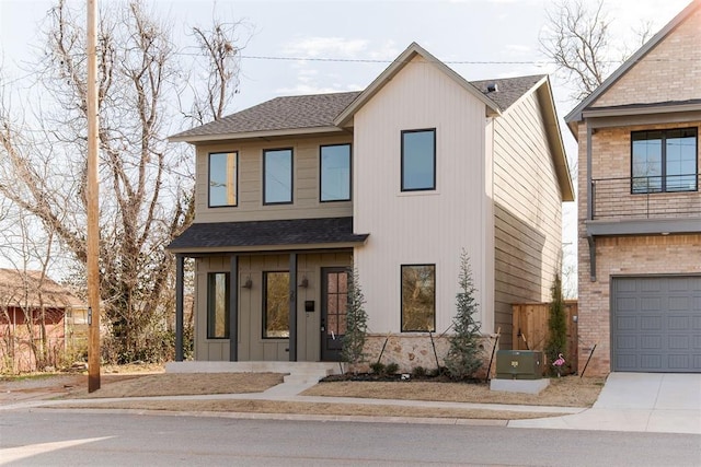 view of front of property with board and batten siding, brick siding, driveway, and a shingled roof