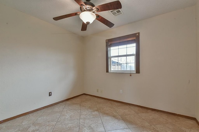 spare room with visible vents, baseboards, a textured ceiling, and ceiling fan