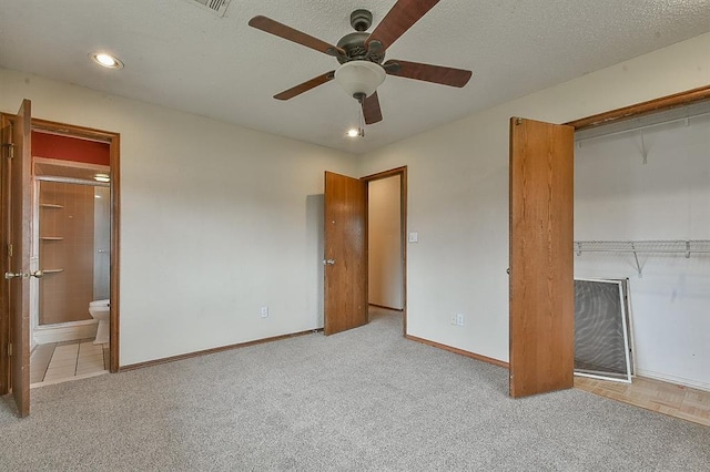 unfurnished bedroom featuring a closet, baseboards, a textured ceiling, and carpet flooring