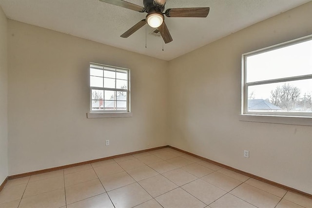 spare room featuring baseboards and ceiling fan