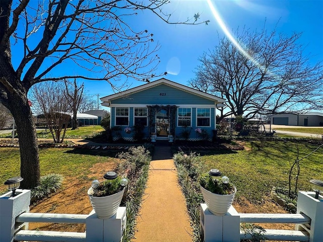 view of front of home with a fenced front yard and a front yard