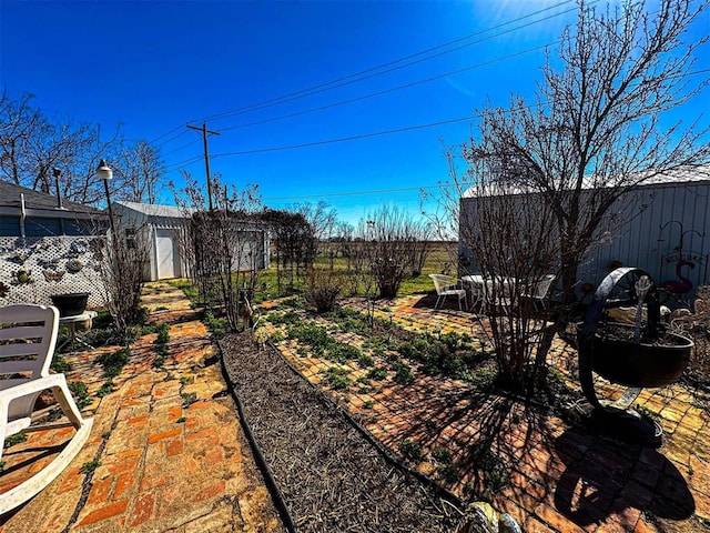 view of yard with an outbuilding and fence