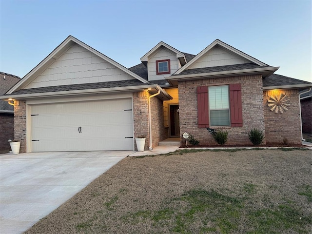 view of front of house featuring a garage, driveway, a front yard, and roof with shingles