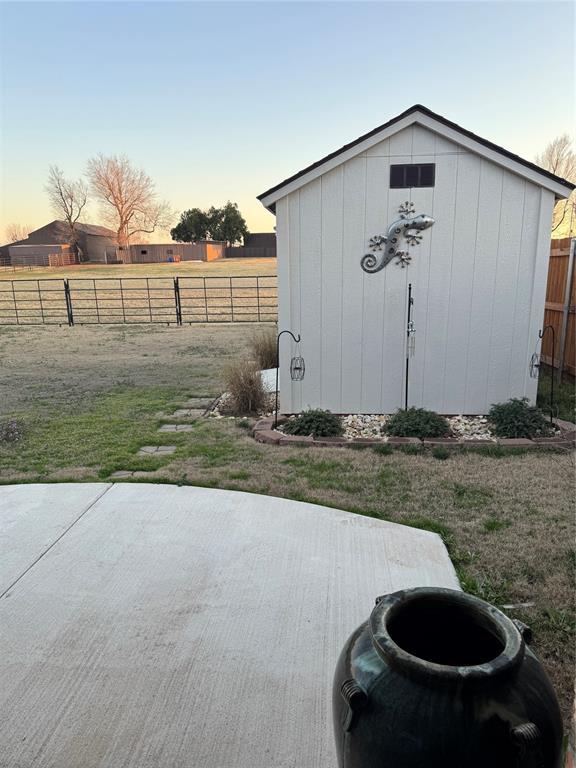 view of shed featuring fence