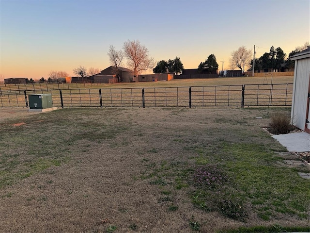 view of yard with a rural view and an enclosed area