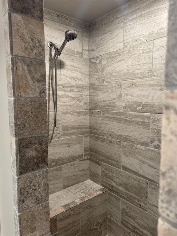 full bath featuring a tile shower