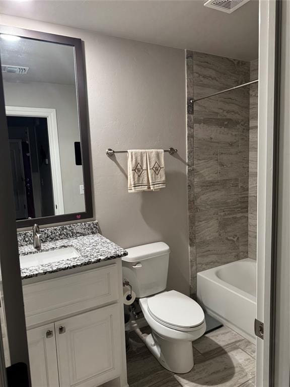 bathroom with visible vents, shower / bathtub combination, toilet, and vanity