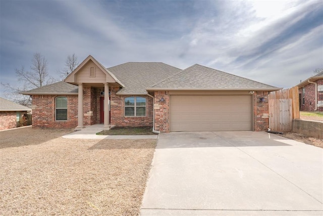 ranch-style home featuring a garage, brick siding, driveway, and a shingled roof