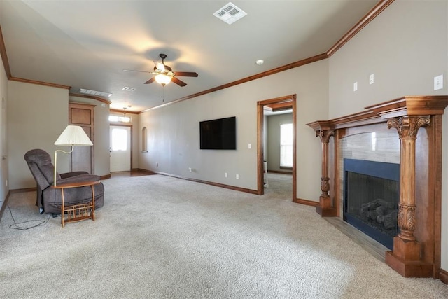 living area with visible vents, baseboards, ceiling fan, light carpet, and a fireplace