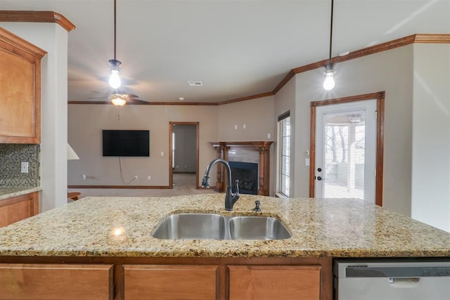 kitchen with brown cabinetry, visible vents, a sink, dishwasher, and open floor plan