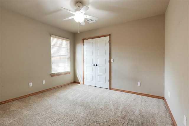 unfurnished bedroom featuring a closet, carpet flooring, visible vents, and baseboards