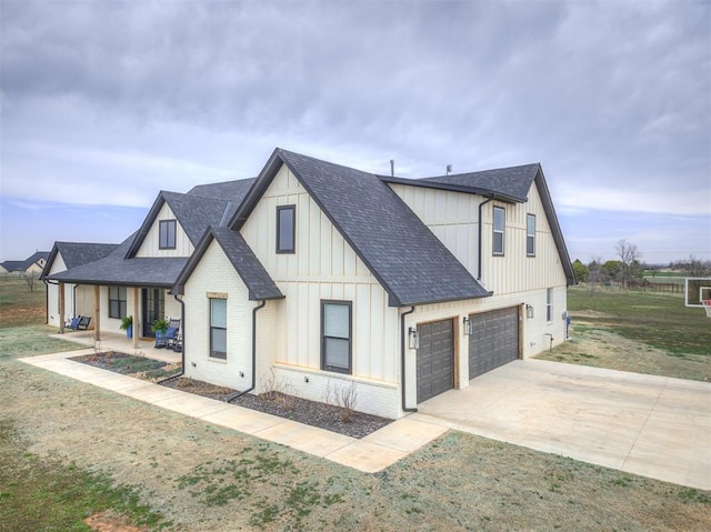 19000 Bobcat Ridge Ct, Cashion, OK 73016 - modern farmhouse featuring roof with shingles, driveway, board and batten siding, brick siding, and a garage
