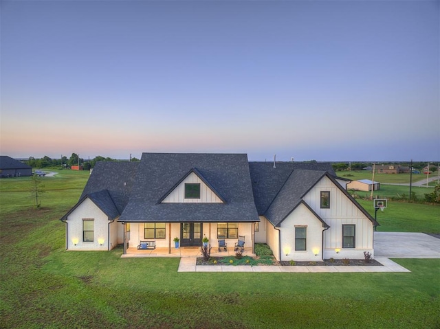 19000 Bobcat Ridge Ct, Cashion, OK 73016 - view of front facade featuring a yard, covered porch, roof with shingles, and french doors