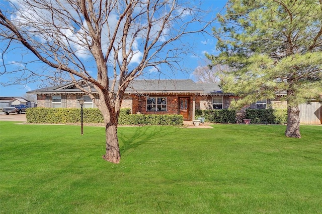 single story home with brick siding and a front yard