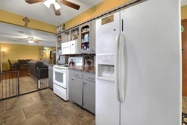 kitchen with white appliances, a ceiling fan, open shelves, a textured ceiling, and dark countertops